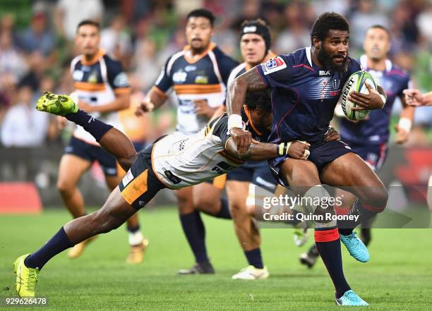 Marika Koroibete of the Rebels breaks through a tackle during the round four Super Rugby match between the Rebels and the Brumbies at AAMI Park on...