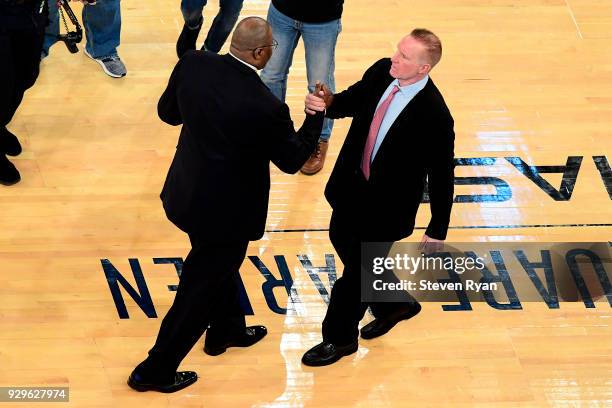 Head coach Patrick Ewing of the Georgetown Hoyas and head coach Chris Mullin of the St. John's Red Storm shake hands prior to the first round of the...