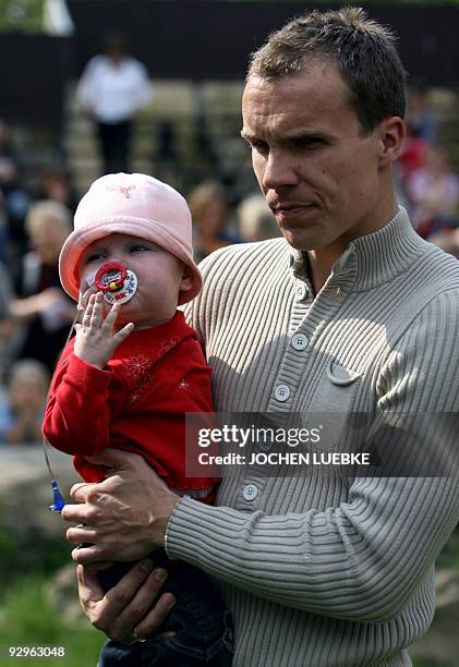 Picture taken on May 8, 2006 shows Robert Enke, goalkeeper of the German Bundesliga football team Hannover 96, carrying his then 19-month-old...