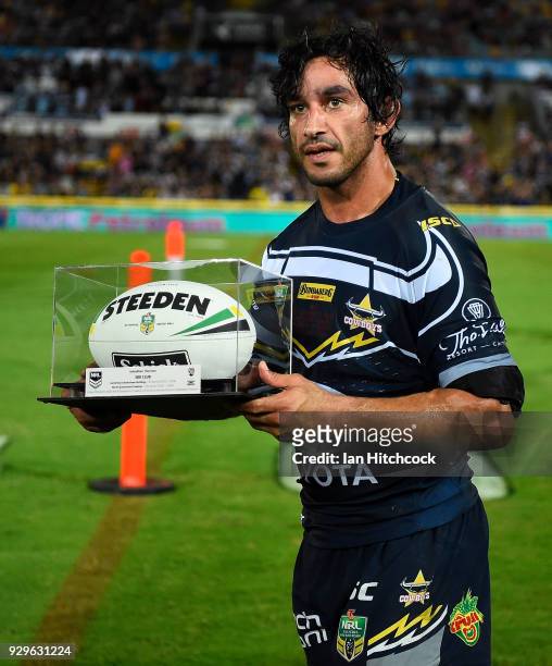 Johnathan Thurston of the Cowboys is presented with the game ball after finishing his 300th NRL game during the round one NRL match between the North...