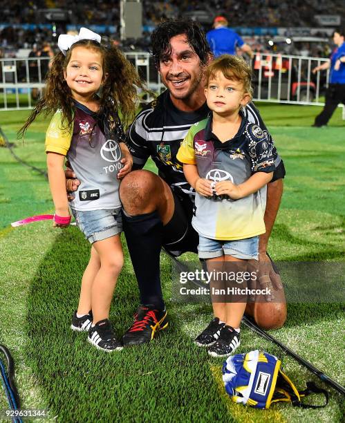 Johnathan Thurston of the Cowboys with his daughters Frankie and Charlie at the end of his 300th NRL match during the round one NRL match between the...