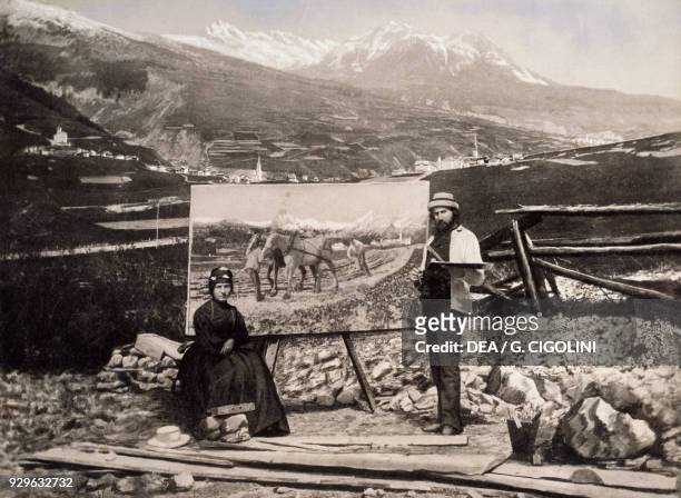 The Italian painter Giovanni Segantini and his wife Bice, in front of the painting Plowing, photograph from ca 1890, 19th century.