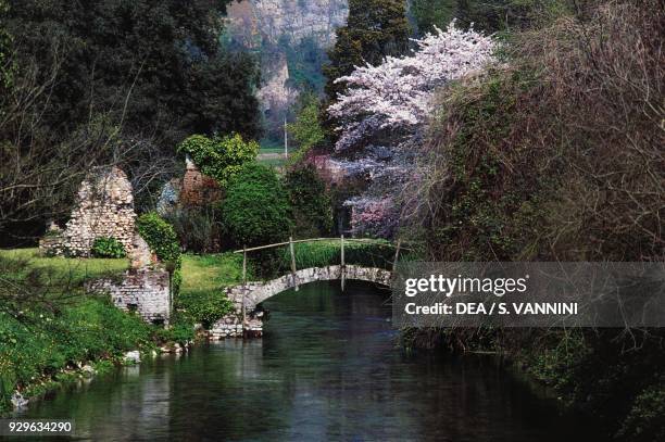 Bridge over Ninfa river, Gardens of Ninfa, WWF Oasis, Cisterna di Latina, Lazio, Italy.