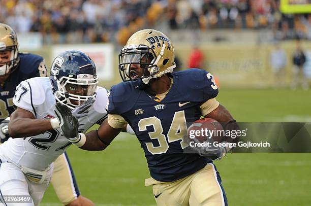 Running back Ray Graham of the University of Pittsburgh Panthers runs against safety Aaron Bagsby of the University of Connecticut Huskies during a...