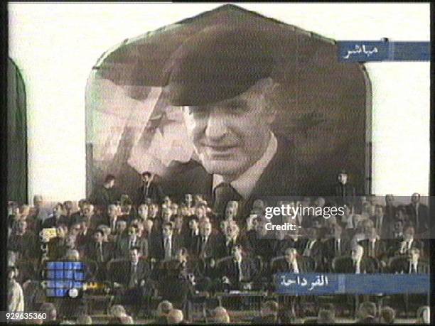 This TV grab from the independent Lebanese Future television station shows a huge portrait of Syria's late president Hafez al-Assad behind Syrian and...