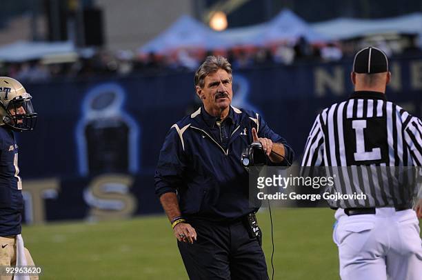 Head coach Dave Wannstedt of the University of Pittsburgh Panthers talks with line judge Kevin Codey during a college football game against the...