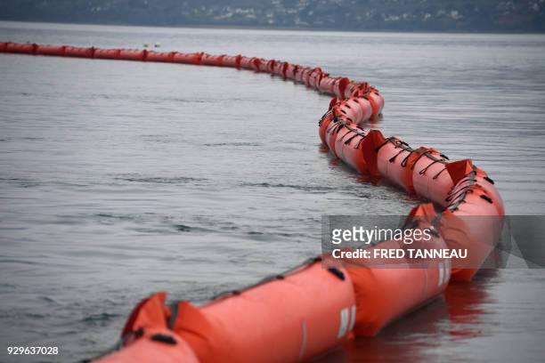 Floating dam is unwinded by the crew of the anti-pollution vessel "Argonaute" during a drill on March 6, 2018 in Brest, western France. On March 16,...