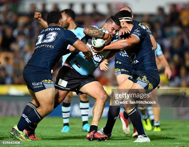Andrew Fifita of the Sharks is tackled by Jason Taumalolo and Jordan McLean of the Cowboys during the round one NRL match between the North...