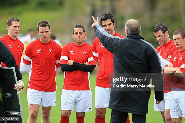 Ricki Herbert head coach of the All Whites discusses tactics with his team during a New Zealand All Whites training session at Endeavour Park on...