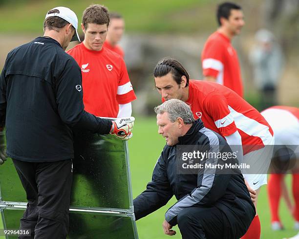 Ricki Herbert head coach of the All Whites discusses tactics with his team during a New Zealand All Whites training session at Endeavour Park on...