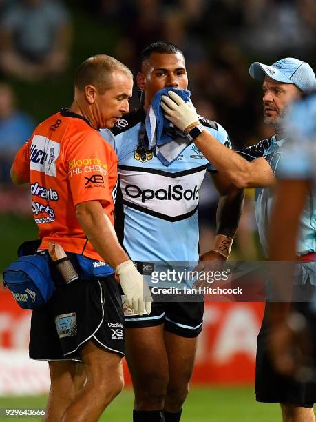 Sione Katoa of the Sharks comes from the field after being injured during the round one NRL match between the North Queensland Cowboys and the...