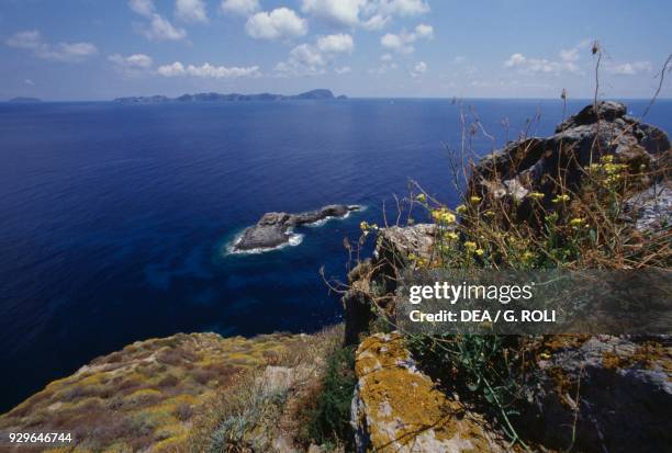 The Rock Hat , Palmarola island, with the Zannone and Ponza islands in the background, Lazio, Italy.