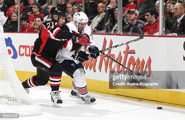 Alexei Kovalev of the Ottawa Senators bumps Lubomir Visnovsky of the Edmonton Oilers off the puck at Scotiabank Place on November 10, 2009 in Ottawa,...