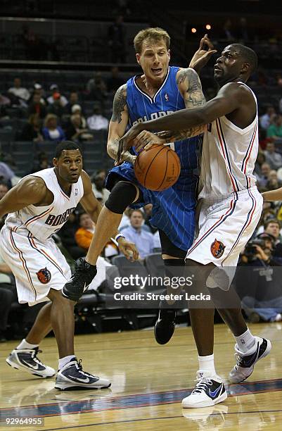 Jason Williams of the Orlando Magic is fouled by Nazr Mohammed of the Charlotte Bobcats during their game at Time Warner Cable Arena on November 10,...