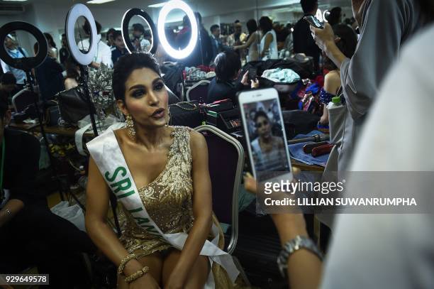 Noel Tokuhisa of Sri Lanka speaks on social media in the dressing room before the final round of the Miss International Queen 2018 transgender beauty...