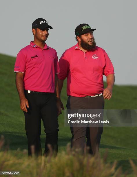 Shubhankar Sharma of India and Andrew Johnston of England walk down the 18th fairway during day two of the Hero Indian Open at Dlf Golf and Country...