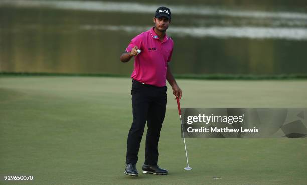 Shubhankar Sharma of India celebrates a birdie putt on the 18th green during day two of the Hero Indian Open at Dlf Golf and Country Club on March 9,...