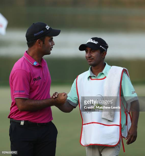 Shubhankar Sharma of India celebrates his round with his caddie after day two of the Hero Indian Open at Dlf Golf and Country Club on March 9, 2018...