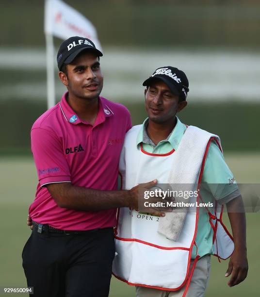Shubhankar Sharma of India celebrates his round with his caddie after day two of the Hero Indian Open at Dlf Golf and Country Club on March 9, 2018...