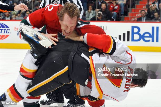 Travis Moen of the Montreal Canadiens tangles with Adam Pardy of the Calgary Flames during the NHL game on November 10, 2009 at the Bell Centre in...