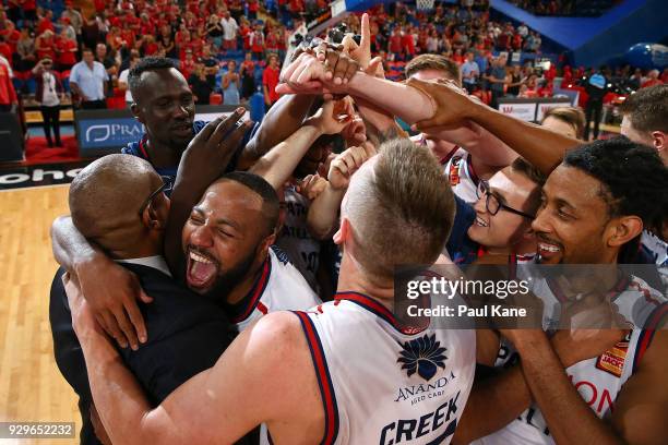 The 36ers celebrate with head coach Joey Wright after winning game two of the NBL Semi Final series between the Adelaide 36ers and the Perth Wildcats...