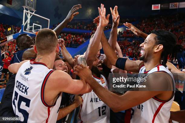 The 36ers celebrate after winning game two of the NBL Semi Final series between the Adelaide 36ers and the Perth Wildcats at Perth Arena on March 9,...