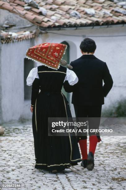 Couple wearing traditional costume, woman wearing a typical Molise headdress , Roccamandolfi, Molise, Italy.