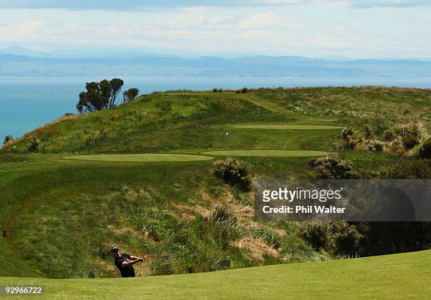 Hunter Mahan of the USA plays an approach shot on the 11th hole during the first round of The Kiwi Challenge at Cape Kidnappers on November 11, 2009...