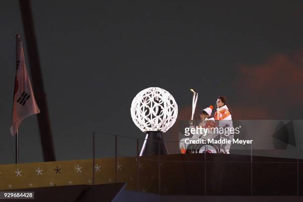 Seo Soonseok and Kim EunJung carries the torch during the opening ceremony of the PyeongChang 2018 Paralympic Games at the PyeongChang Olympic...