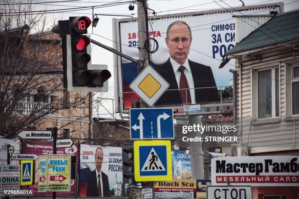 Campaign billboards of Russian President Vladimir Putin, reading "Simferopol for the Strong Russia! Vladir Putin" are seen in Simferopol on March 9,...