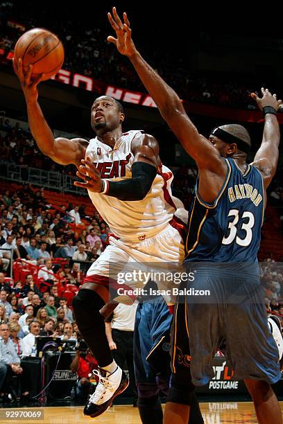 Dwyane Wade of the Miami Heat shoots against Brendan Haywood of the Washington Wizards on November 10, 2009 at American Airlines Arena in Miami,...