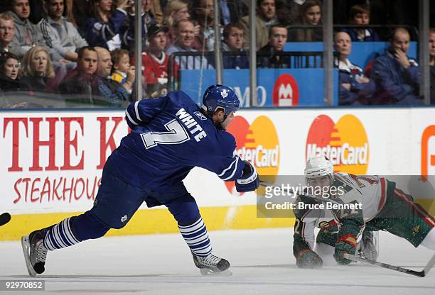 Cal Clutterbuck of the Minnesota Wild falls to the ice to block a shot by Ian White of the Toronto Maple Leafs at the Air Canada Centre on November...