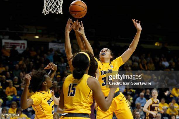 Toledo Rockets forward Jada Woody reaches to grab a rebound during a regular season Mid-American Conference game between the Central Michigan...