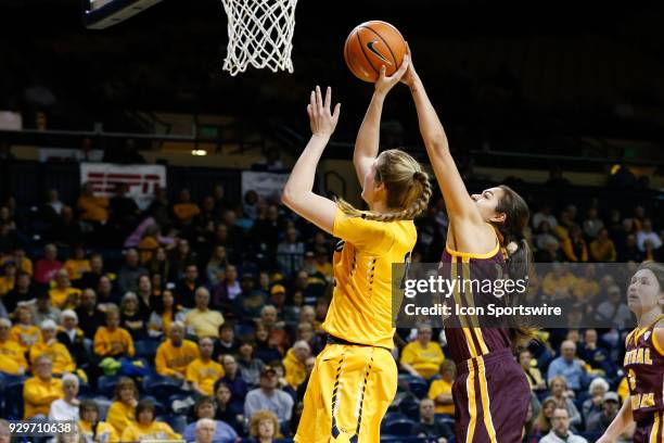 Toledo Rockets forward Michaela Rasmussen goes in for a layup against Central Michigan Chippewas forward Reyna Frost during a regular season...