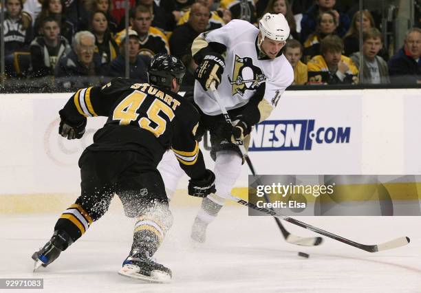Jordan Staal of the Pittsburgh Penguins takes a shot as Mark Stuart of the Boston Bruins defends on November 10, 2009 at the TD Garden in Boston,...