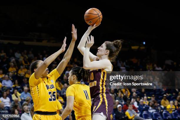 Central Michigan Chippewas guard Cassie Breen shoots over Toledo Rockets forward Jada Woody during a regular season Mid-American Conference game...