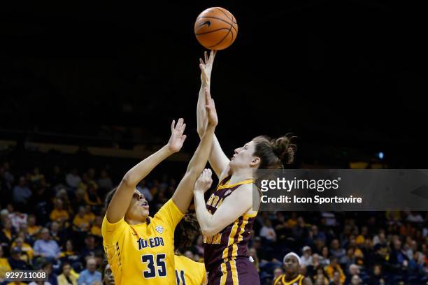 Central Michigan Chippewas guard Cassie Breen shoots over Toledo Rockets forward Jada Woody during a regular season Mid-American Conference game...