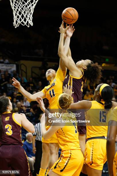 Toledo Rockets guard Jay-Ann Bravo-Harriott and Central Michigan Chippewas forward Tinara Moore battle to grab a rebound during a regular season...