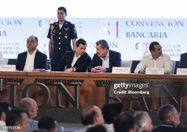 Mexican President Enrique Pena Nieto, center left, speaks with Marcos Martinez Gavica, chairman of Grupo Financiero Santander Mexico SAB, center...