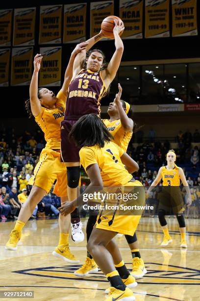 Central Michigan Chippewas forward Reyna Frost grabs a rebound over Toledo Rockets guard Jay-Ann Bravo-Harriott and Toledo Rockets center Kaayla...