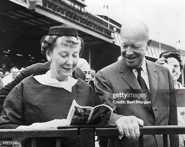 General and Mrs Dwight Eisenhower looking at a racing bill at the Belmont Park racetrack, Elmont, NY, June 3, 1961