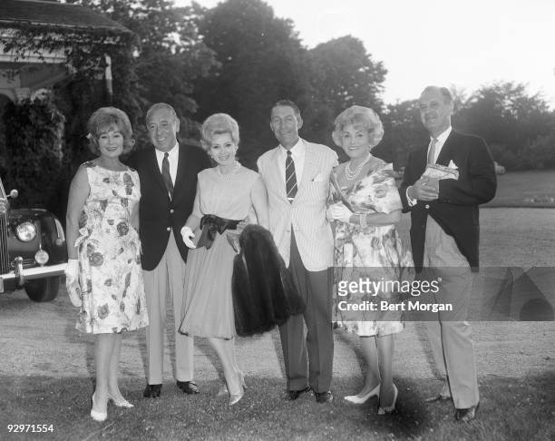 Magda and Zsa Zsa Gabor with their mother Jolie and three unidentified male companions outdoors, 1960s