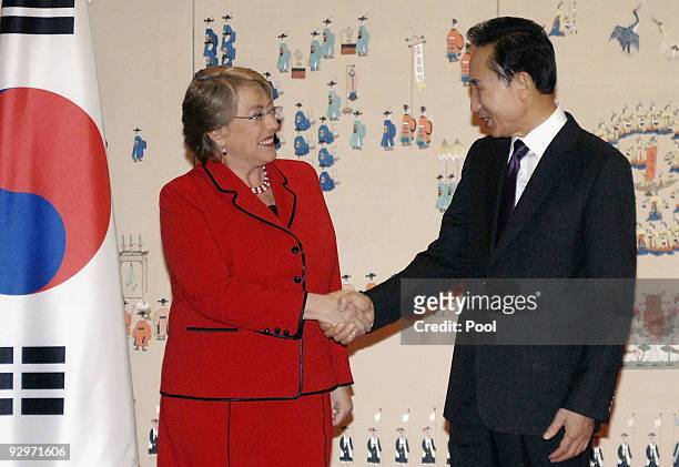 Chile President Michelle Bachelet shakes hands with South Korean President Lee Myung-bak prior to their meeting at Presidential Blue House on...