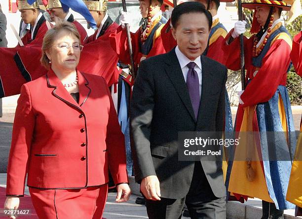 Chile President Michelle Bachelet and South Korean President Lee Myung-Bak walk towards a guard of honour during a welcoming ceremony held at the...