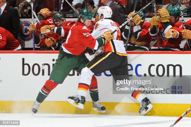 Ryan White of the Montreal Canadiens and Cory Sarich of the Calgary Flames collide along the boards in NHL action on November 10, 2009 at the Bell...