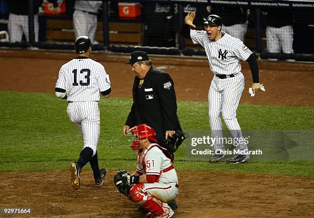 Mark Teixeira and Alex Rodriguez of the New York Yankees celebrate after they scored on a 2-run double by Hideki Matsui in the bottom of the fifth...