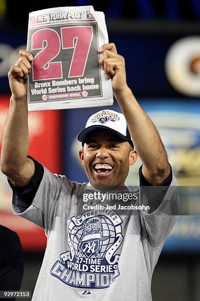 Mariano Rivera of the New York Yankees holds up a copy of the New York Post as he celebrates their 7-3 win against the Philadelphia Phillies in Game...