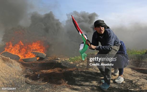 Palestinian protesters burn tyres in response to Israeli forces' intervention during a demonstration to protest against U.S. President Donald Trump's...