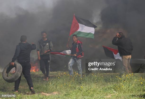 Palestinian protesters burn tyres in response to Israeli forces' intervention during a demonstration to protest against U.S. President Donald Trump's...