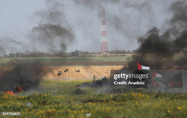 Palestinian protesters burn tyres in response to Israeli forces' intervention during a demonstration to protest against U.S. President Donald Trump's...